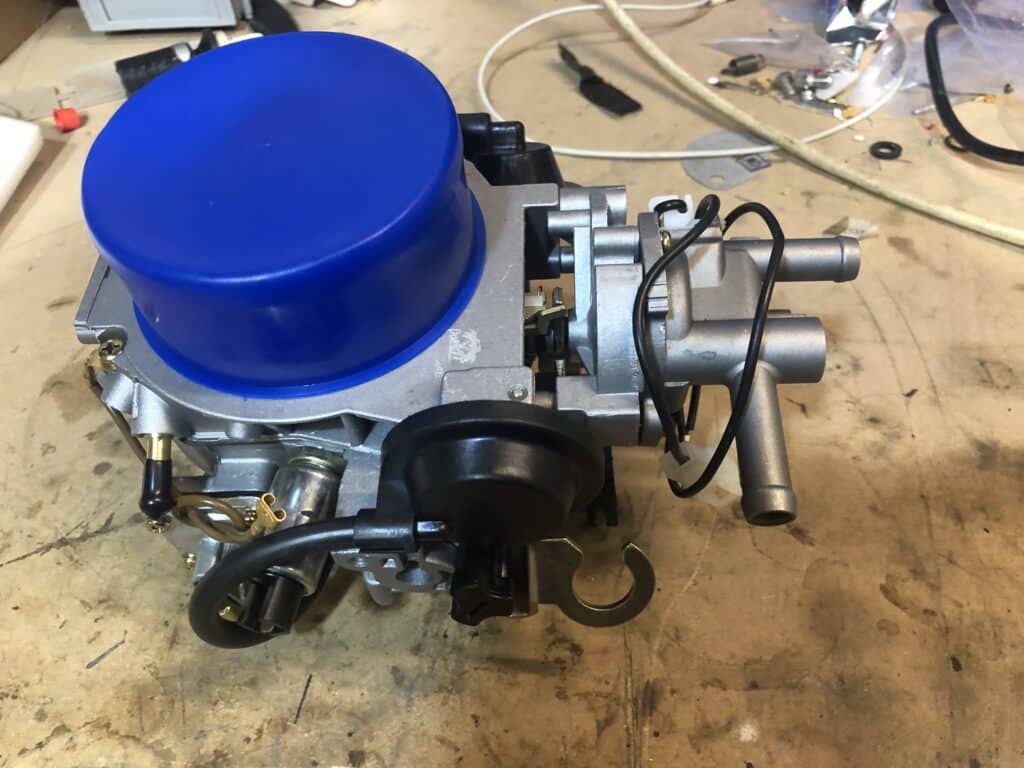 Top view of the Paruzzi 2E3 carburettor as removed from the shipping box, with its blue protector to prevent dirt entering the unit
