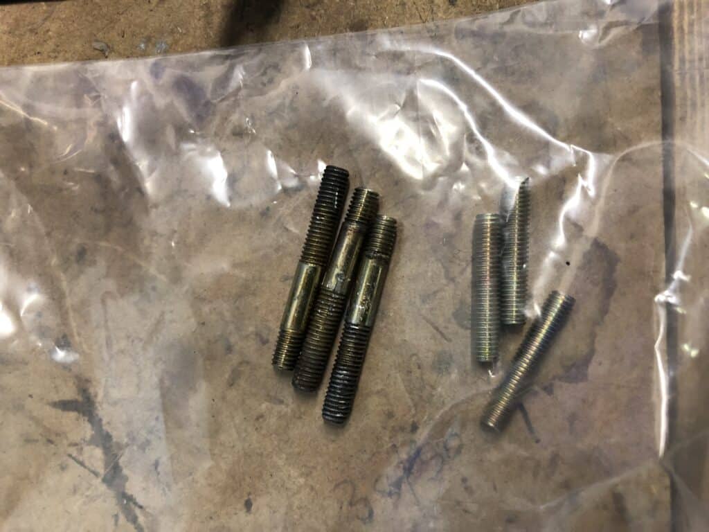 The threaded studs in a bag supplied with the Paruzzi 2E3 carburettor, and the three removed from the Pierburg 2E3 carburettor which are a different length
