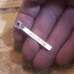 One reed held in the hand showing the improved surface finish resulting from cleaning