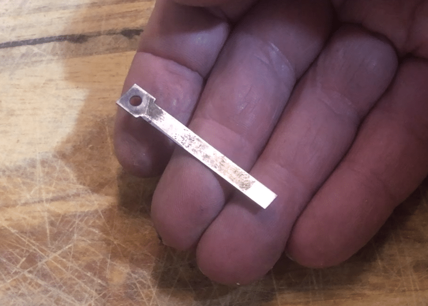 One reed held in the hand showing the improved surface finish resulting from cleaning